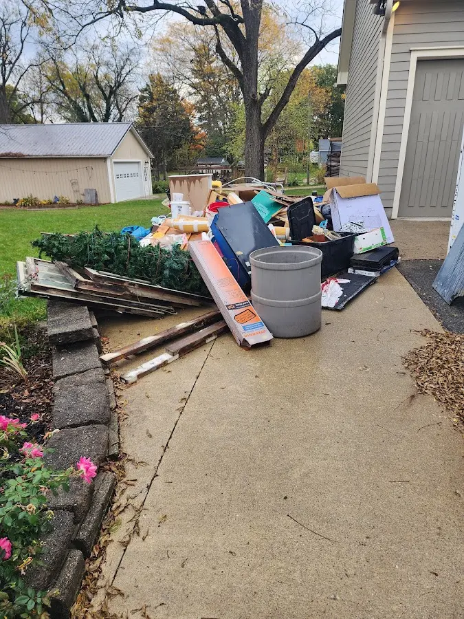 Dumpster being loaded with debris for Estate Cleanout Dumpster Rental in Palm Harbor